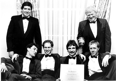 (Left to right seated) Standard reporters; Kevin McMahon, Doug Herod, Michael Clarkson and Kevin Cavanagh; standing left, Standard publisher, Henry Burgoyne; standing right, Standard managing editor Murray Thomson.