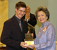 Philippe Cantin of La Presse, accepts Michener Award from Governor General Adrienne Clarkson.